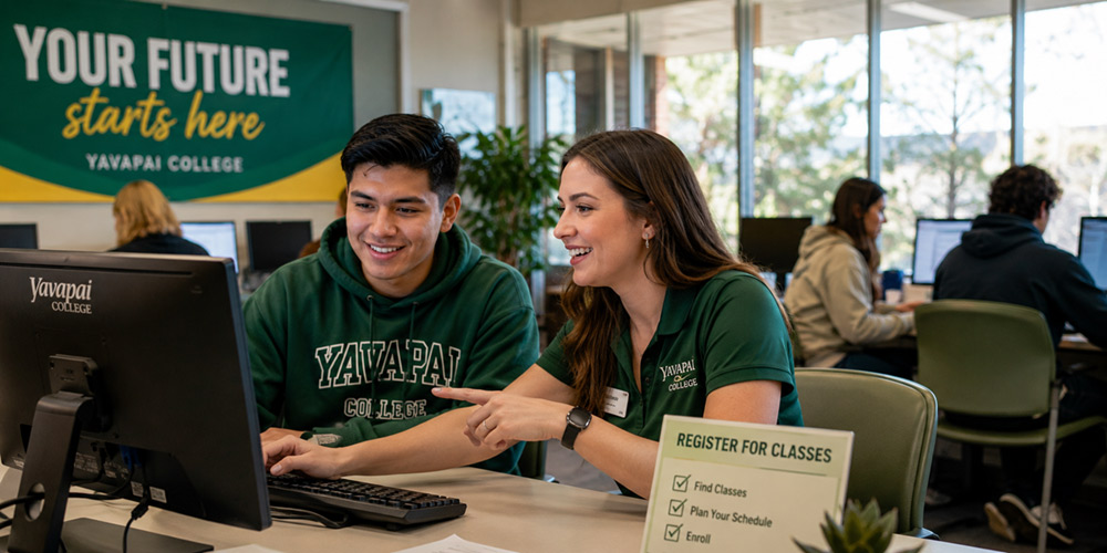 Yavapai College student receiving help with class registration at a campus computer station
