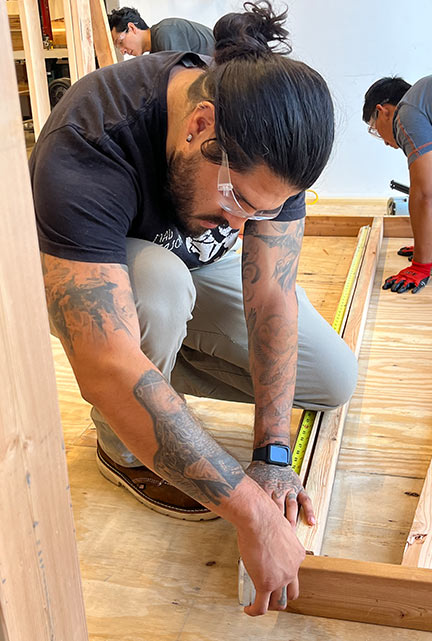 Student practicing carpentry skills in the Skilled Trades Center