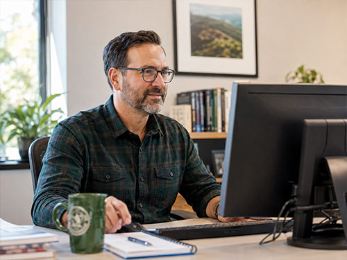 Faculty member reviewing class information on a computer