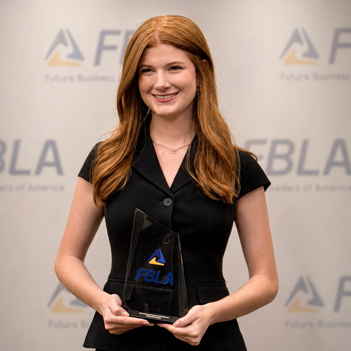 Campbell Augustinovich holding an FBLA award