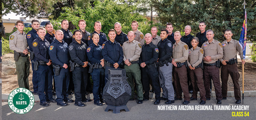 NARTA Class 54 graduates standing together outdoors in agency uniforms