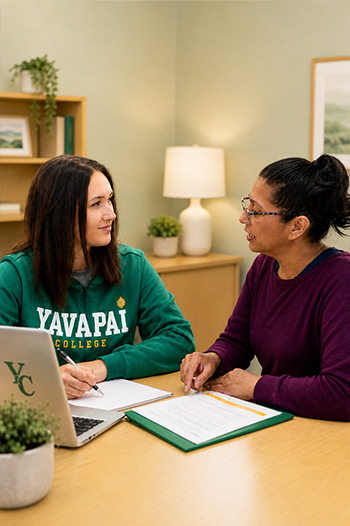 YC staff member talking with a student in a supportive setting